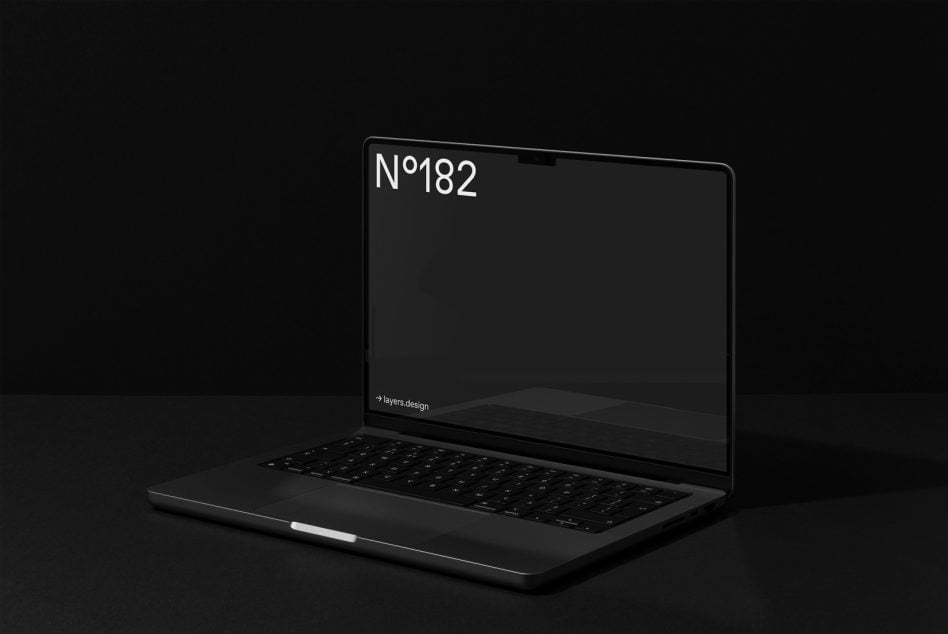 Dark laptop on black surface with black screen labeled N°182