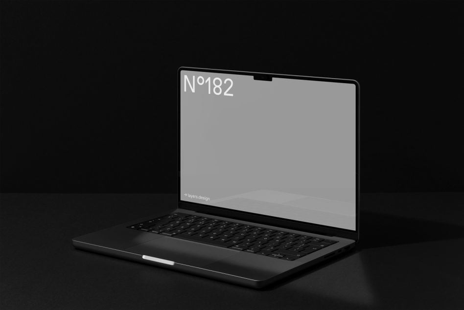Open laptop on black surface with gray screen displaying N°182