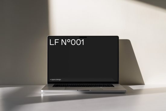 Laptop mockup with sleek design on desk casting shadow, for digital asset showcase, highlighting modern fonts and clean presentation.