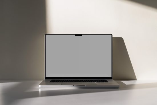 Modern laptop mockup on a desk with a shadow, blank screen for design presentation, digital asset for graphic designers.