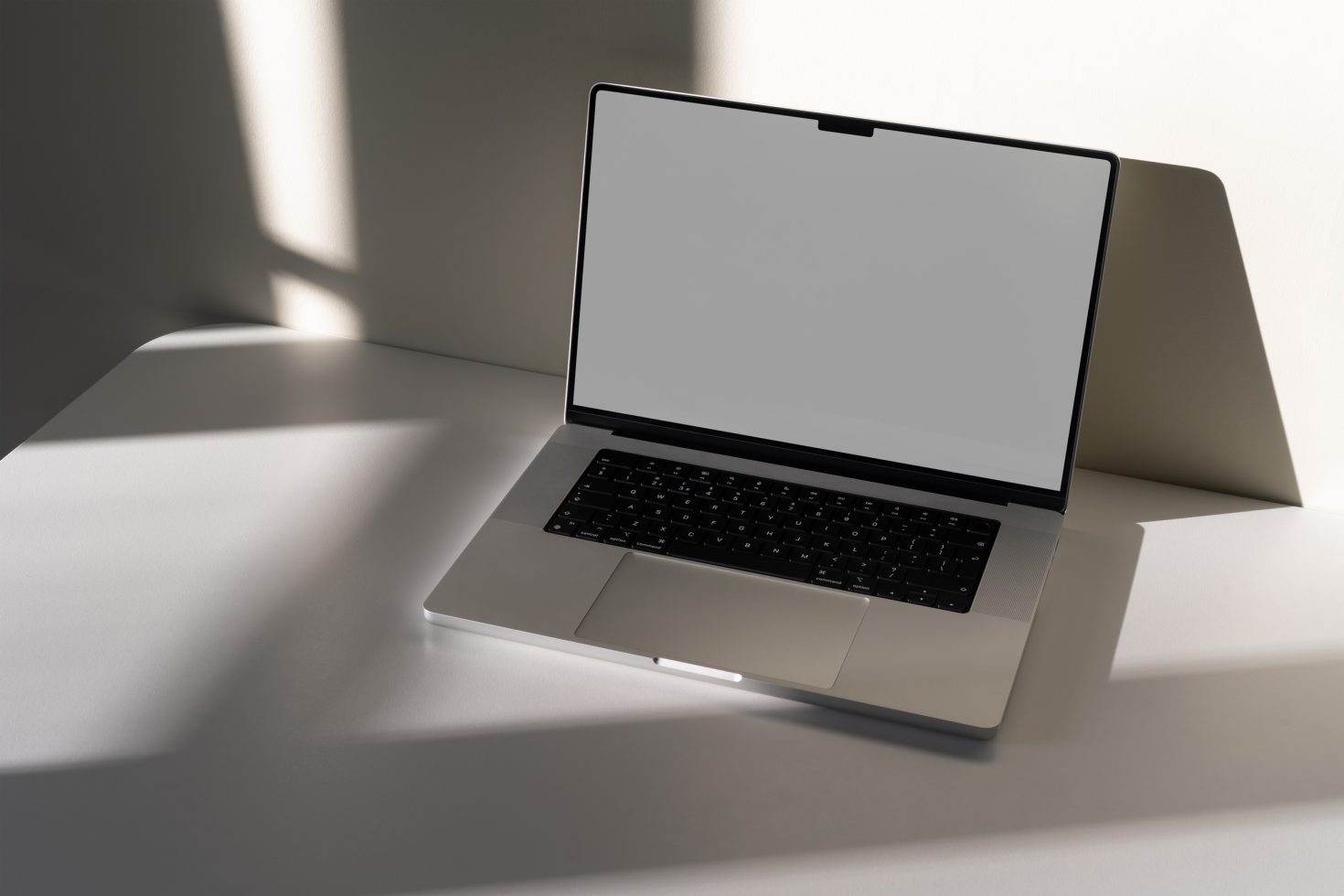 Laptop mockup on a white table with shadows, modern design, available for product display, ideal for graphic designers and template display.