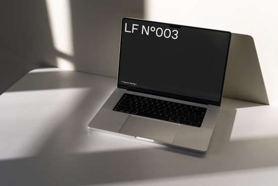 Laptop mockup with sleek design, sunlit minimalist setting, ideal for presentations, digital assets portfolio display, and designer workflows.