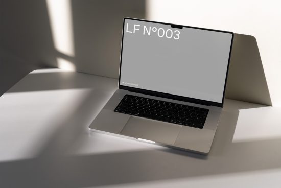 Laptop mockup with shadow on white desk, modern design template for digital asset display, clean minimalistic style.