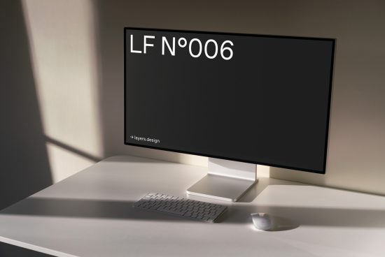 Minimalist computer monitor mockup on desk with keyboard and mouse for design presentation, sleek workspace setup with soft lighting.