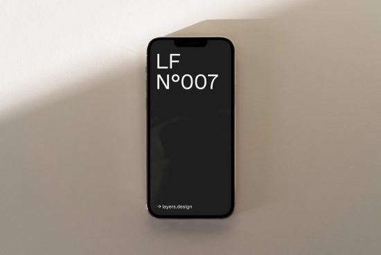 Modern smartphone mockup with minimalist font design displayed on screen, ideal for showcasing apps and responsive web design in a realistic setting.