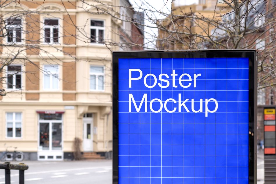 Urban street poster mockup on billboard with clear grid lines for design presentations, set against a blurred building backdrop.