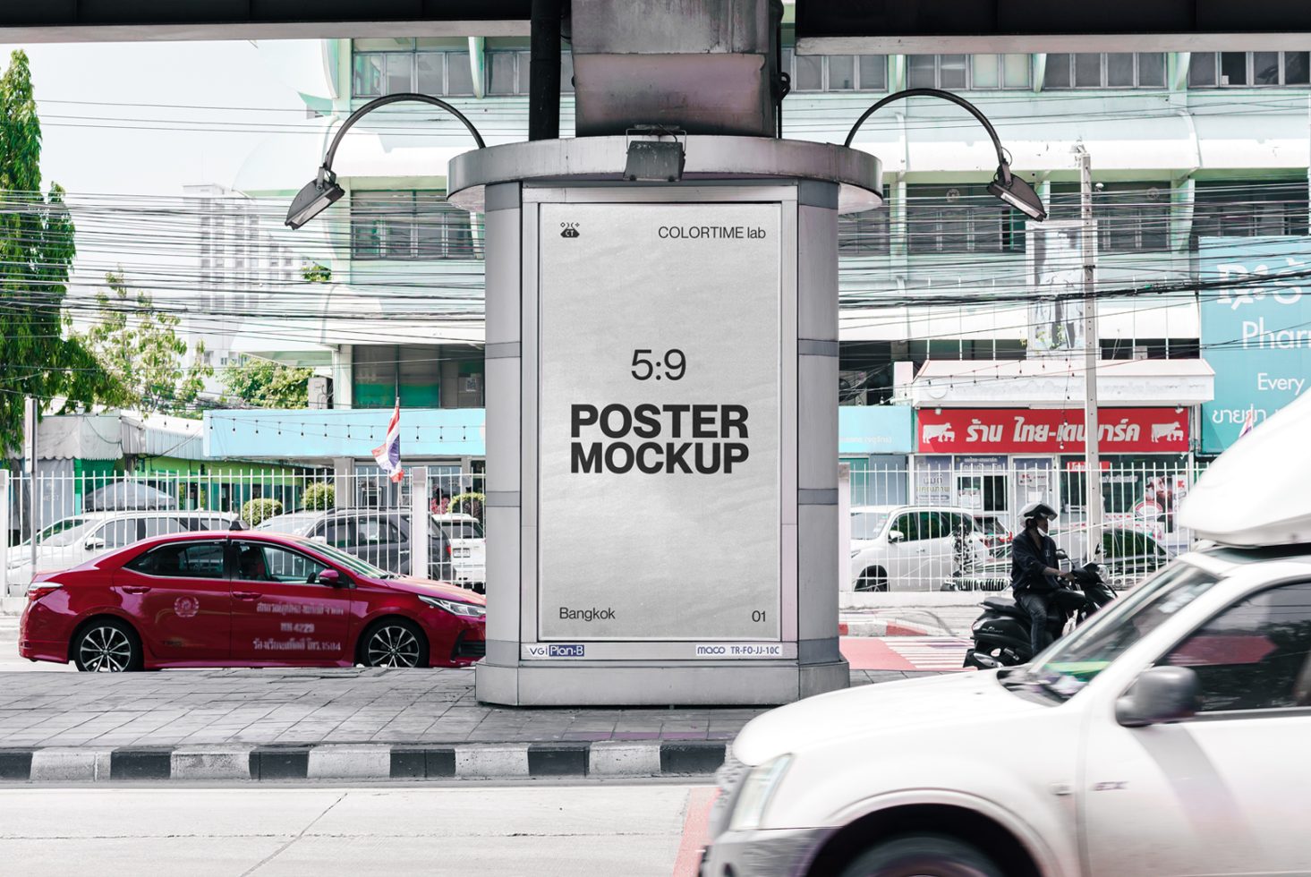 Urban outdoor poster mockup on a cylindrical advertising column with vehicles and city backdrop, suitable for graphic design and branding presentations.