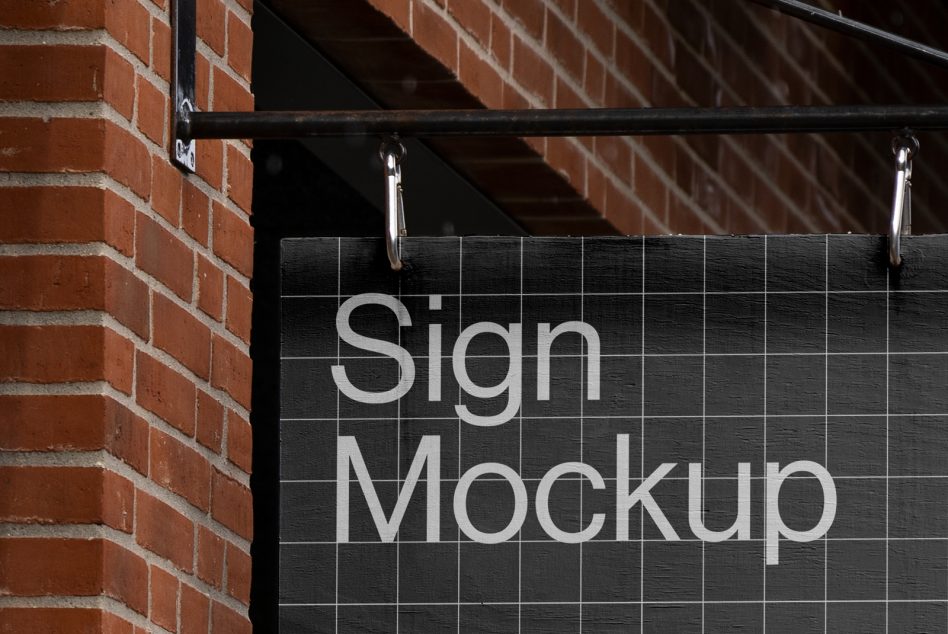 Realistic sign mockup hanging on a brick wall, perfect for brand presentation, graphics display, and storefront design mockups.