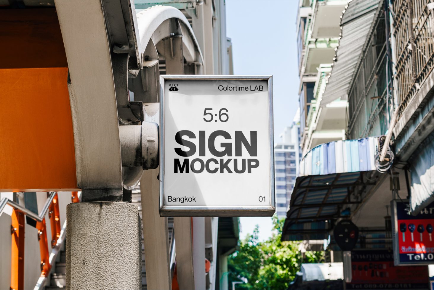 Urban street sign mockup hanging on a building corner with clear skies, showcasing design space for logos or advertisements.