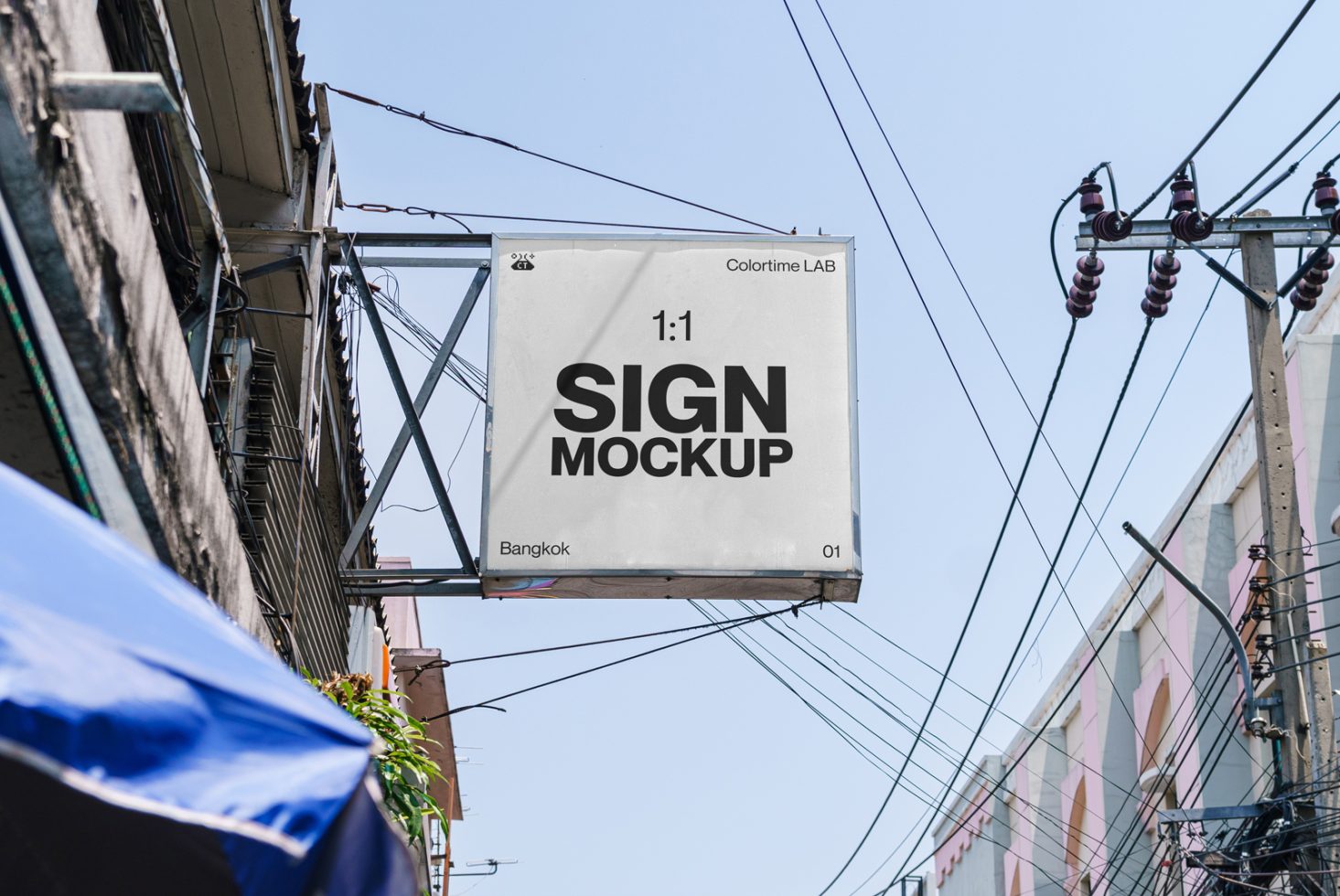 Urban street sign mockup hanging on a building against a clear blue sky, showcasing design space for branding in Bangkok, perfect for graphic designers.