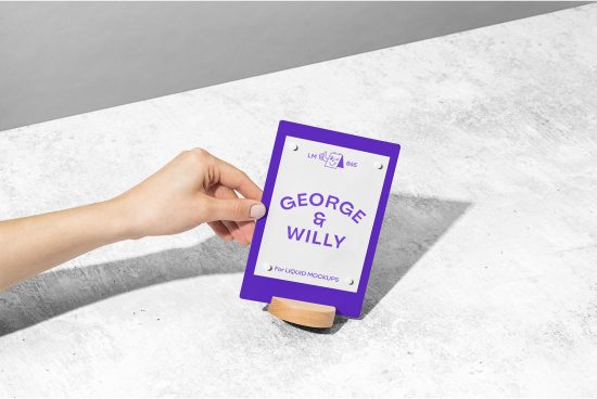 Hand holding a purple business card mockup with a minimalistic design on a textured grey surface, perfect for showcasing branding identity designs.