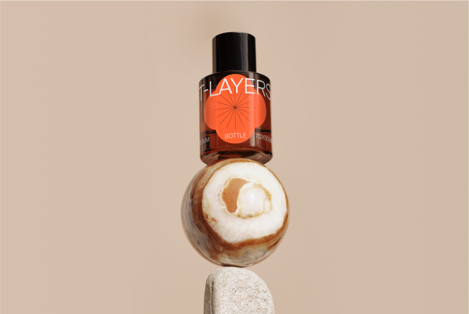 Cosmetic bottle mockup with orange label on marble sphere with neutral background