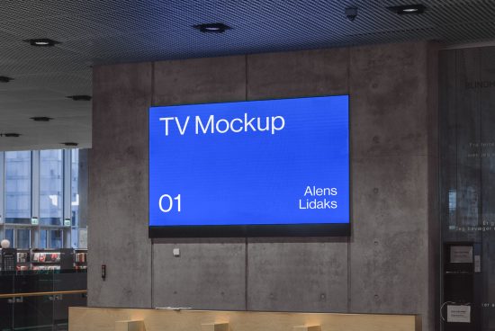 Large flat-screen TV mockup displaying blue screen with text, mounted in modern office lobby, ideal for presentations and advertising.