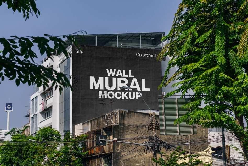 Urban setting with green foliage showing a wall mural mockup, great for designers looking for realistic graphic templates for branding.