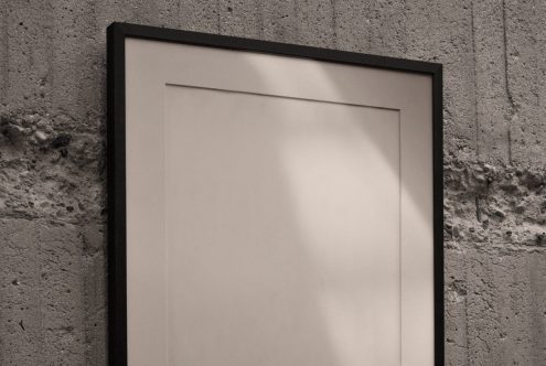 Blank poster frame mockup on concrete wall, modern display, gallery template, editable PSD design for artists and designers.