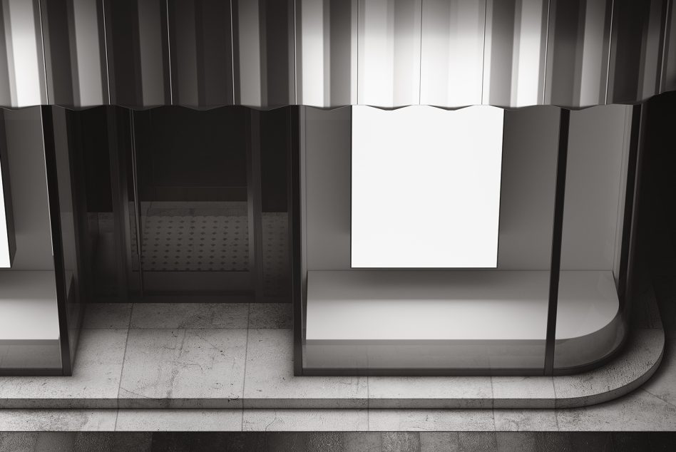 Minimalist retail storefront with white panel display surrounded by dark glass partitions