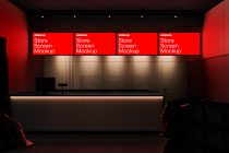 Modern retail store interior with red lighting featuring digital screen mockups for design presentations.