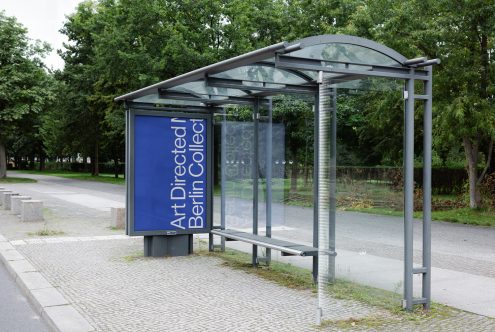 Bus stop billboard mockup with clear sky in urban park setting for outdoor advertising presentation and portfolio display.