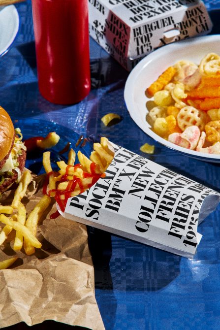 Fast food mockup with burger, fries on blue tabletop, realistic packaging, design template display for branding.