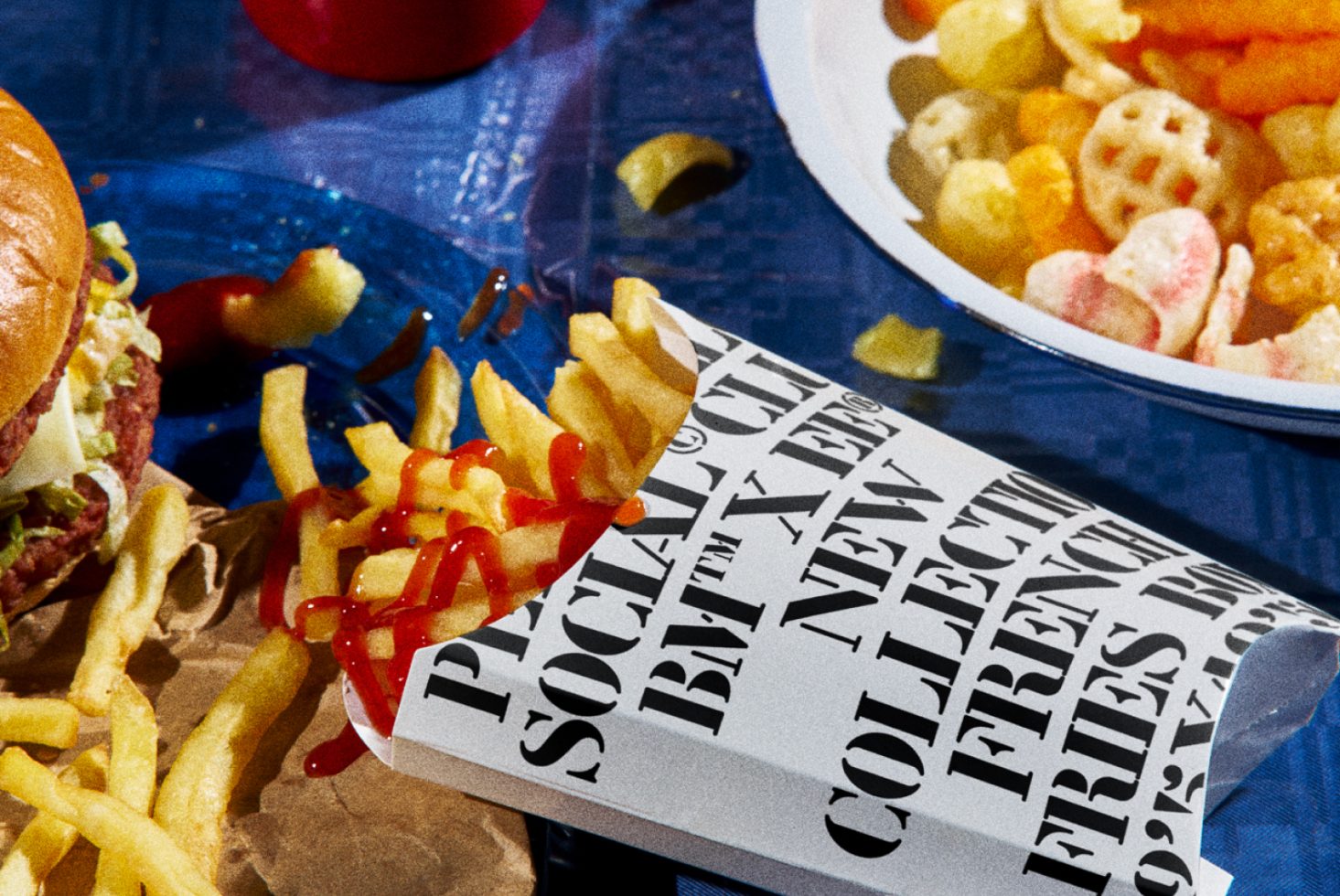 Fast food mockup with burger, fries, and snacks, featuring bold typography on packaging, ideal for graphic design templates.