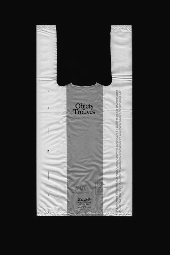 Black and white garment bag mockup with Objets Trouves text, designers can use for branding, fashion, and retail packaging graphics.