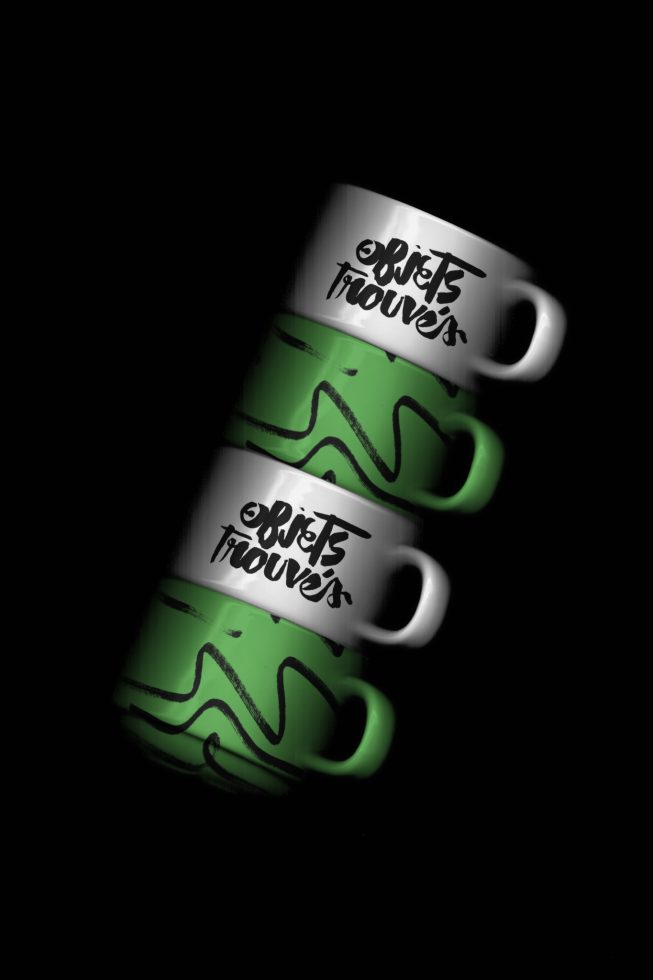 ALT: Green and white branded coffee mugs mockup with unique graffiti-style graphics on a dark background, ideal for presenting product designs.