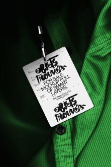 Clothing hang tag mockup with bold typography on bright green fabric background