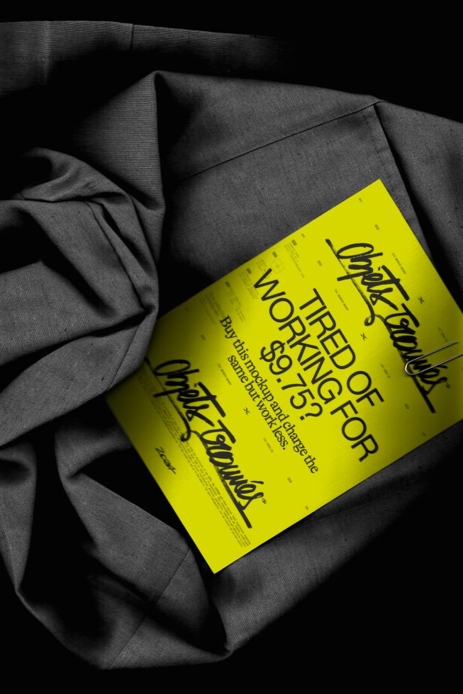 Yellow poster mockup with calligraphic font, draped in dark fabric background, showcasing print design and typography layout for designers.