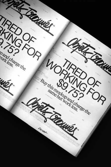 Two white magazine spreads overlapping at angle on black surface