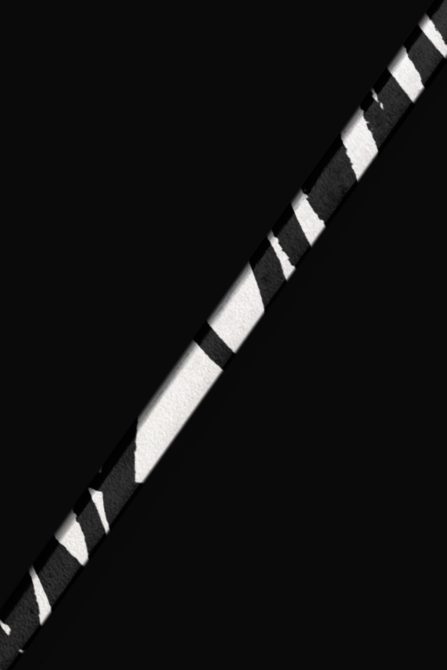 White baseball bat with black wrapped grip section isolated