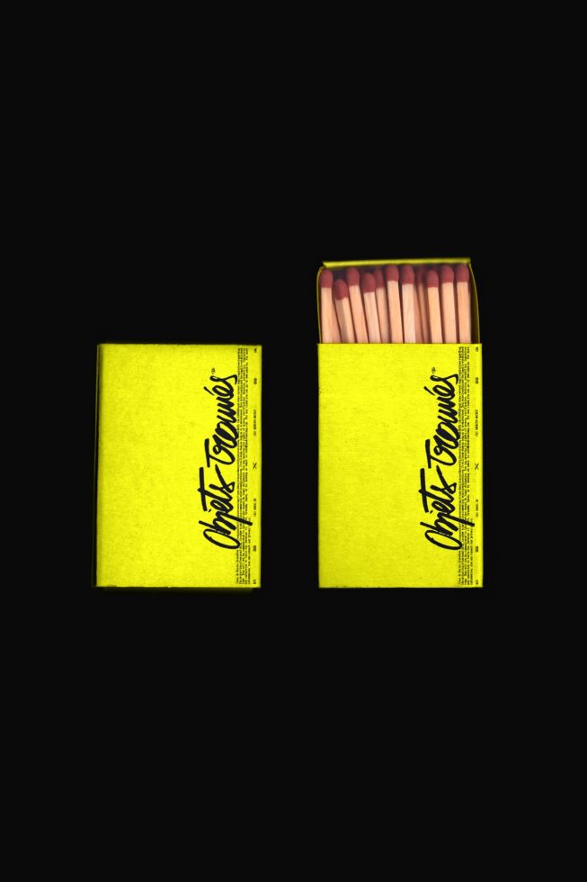 Realistic matchbox mockup with open and closed options, vibrant yellow design, isolated on black, ideal for product packaging design presentations.