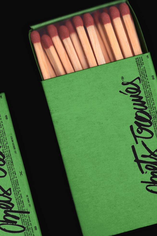 Realistic matchbox mockup with striking green design, showcasing matchsticks inside, ideal for packaging and branding presentations.