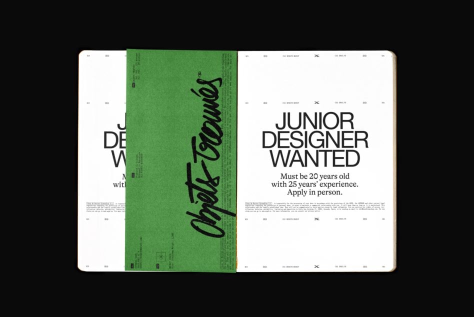 Open magazine spread with humorous job posting mockup on white pages, green center divider with handwritten text overlay