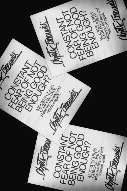 Multiple white poster mockups fanned out showing bold typography layouts with script branding details