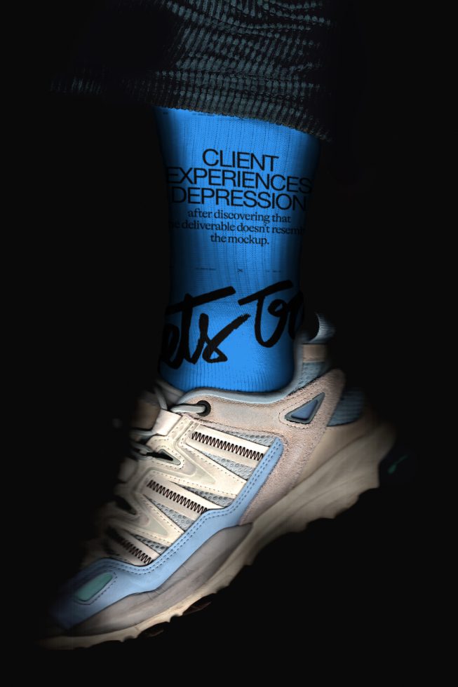 Creative legwear mockup featuring bold typography on blue socks with sneaker, ideal for designers seeking striking apparel presentation.