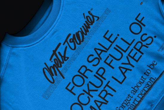 Close-up view of a blue T-shirt mockup with a layered typographic design, suitable for use in graphic presentations and fashion showcases.