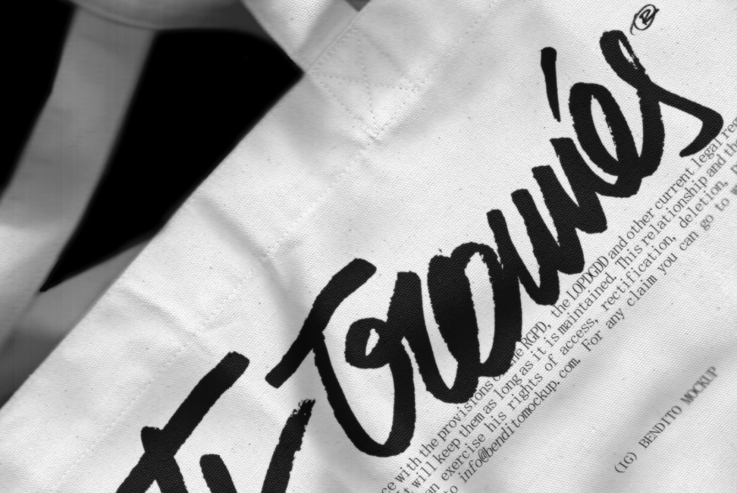 Close-up of fabric texture with bold brush script typography, ideal for designers working on brand mockups, fashion, or textiles graphics.