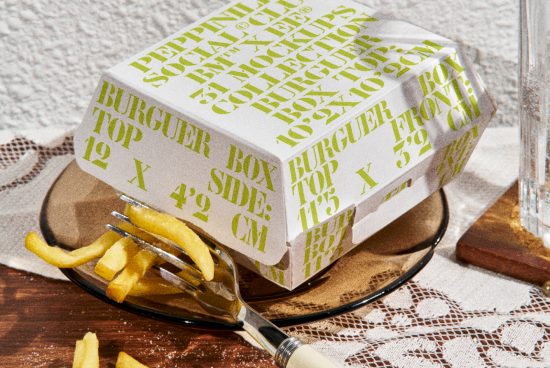 Photorealistic burger box mockup on a plate with fries, showcasing packaging design, print details, and textures for product presentations.