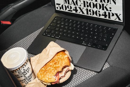 Laptop with stylized text on screen, coffee cup and burger on car seat, depicting on-the-go lifestyle, perfect for mockup graphics category.