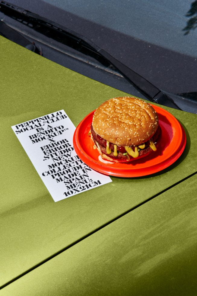 Creative burger mockup on green car hood with typography menu design, showcasing bold fonts and graphic design for branding presentations.