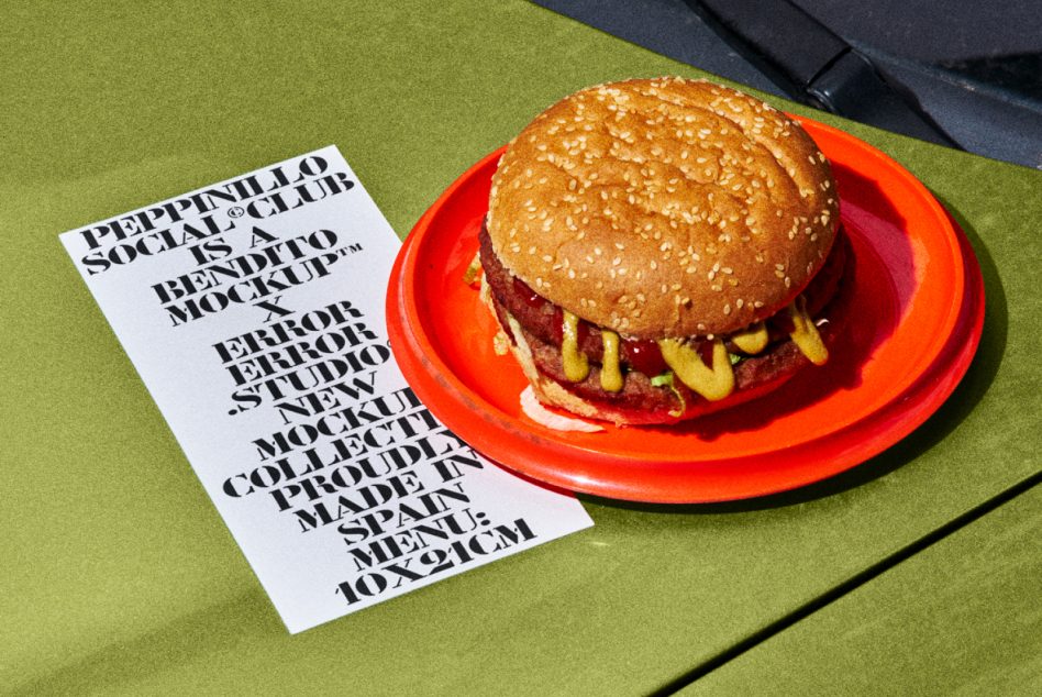 Stylized burger on red plate with trendy graphic design menu mockup on textured green background. Ideal for food mockups, design presentation.