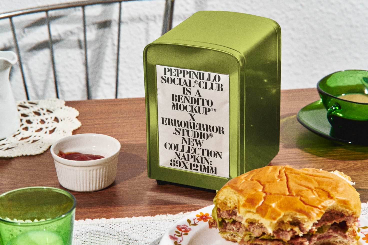 Vintage tin container mockup with typographic design on dining table next to sandwich and coffee, ideal for retro packaging presentations.