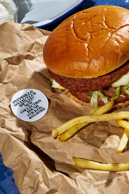 Delicious burger with fries mockup, ideal for restaurant menu design or food app interface, showcasing realistic textures and packaging.