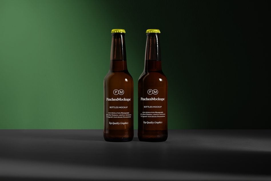 Two beer bottles mockup on green background, editable label design, high-resolution, realistic textures, suitable for branding presentations.