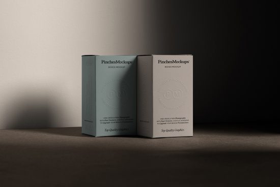 Elegant packaging mockup with two boxes featuring embossed logo, showcasing realistic shadows and textures perfect for design presentations.