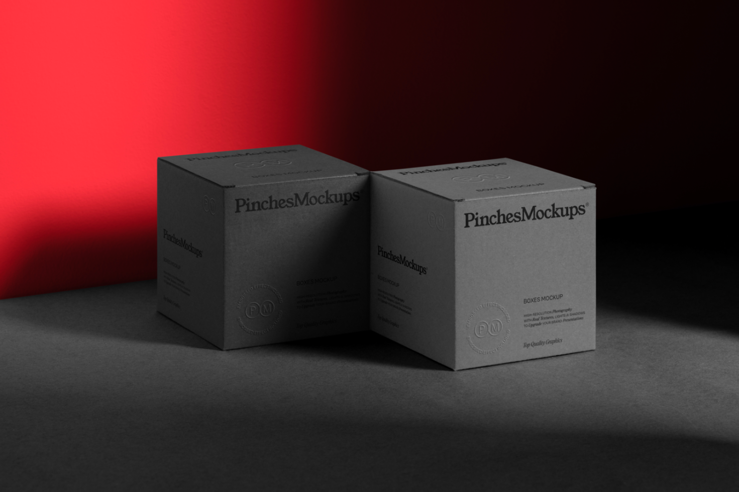 Two elegant black cardboard box mockups on dark surface with dramatic red background, ideal for packaging design presentation.