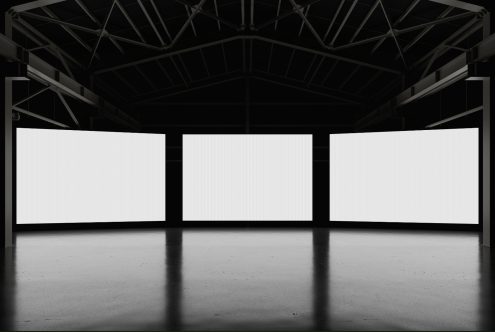 Empty billboard mockups in a dark industrial hall, ideal for ad display design presentations, suitable for graphic designers.