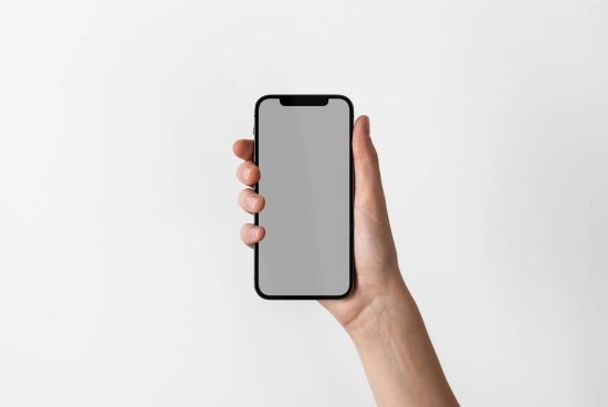 Hand holding modern smartphone with blank screen for mockup design, isolated on white background, ideal for app and web design presentation.