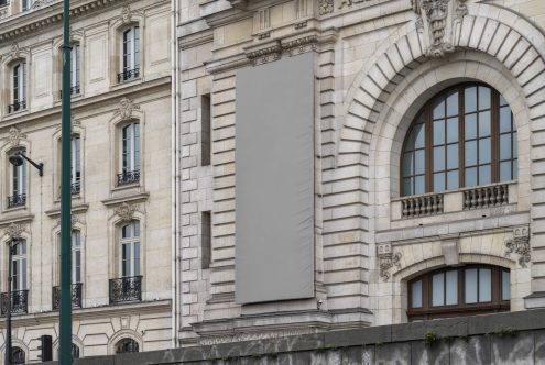 Urban billboard mockup on classic architecture building facade, empty advertising banner for graphic designers and marketers.