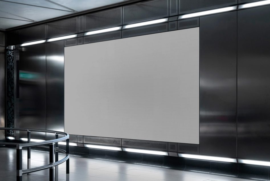 Large horizontal poster frame mounted on dark wall with LED strips above